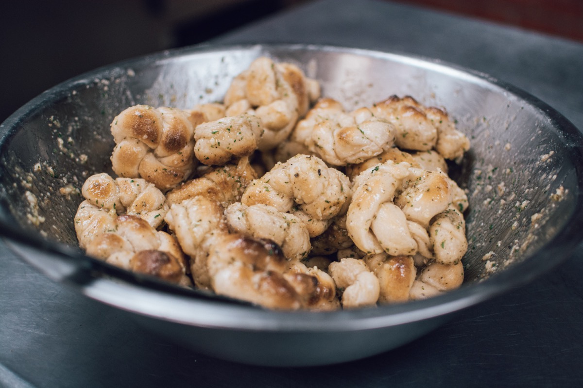 Fresh garlic knots tossed in garlic, oil, and herbs