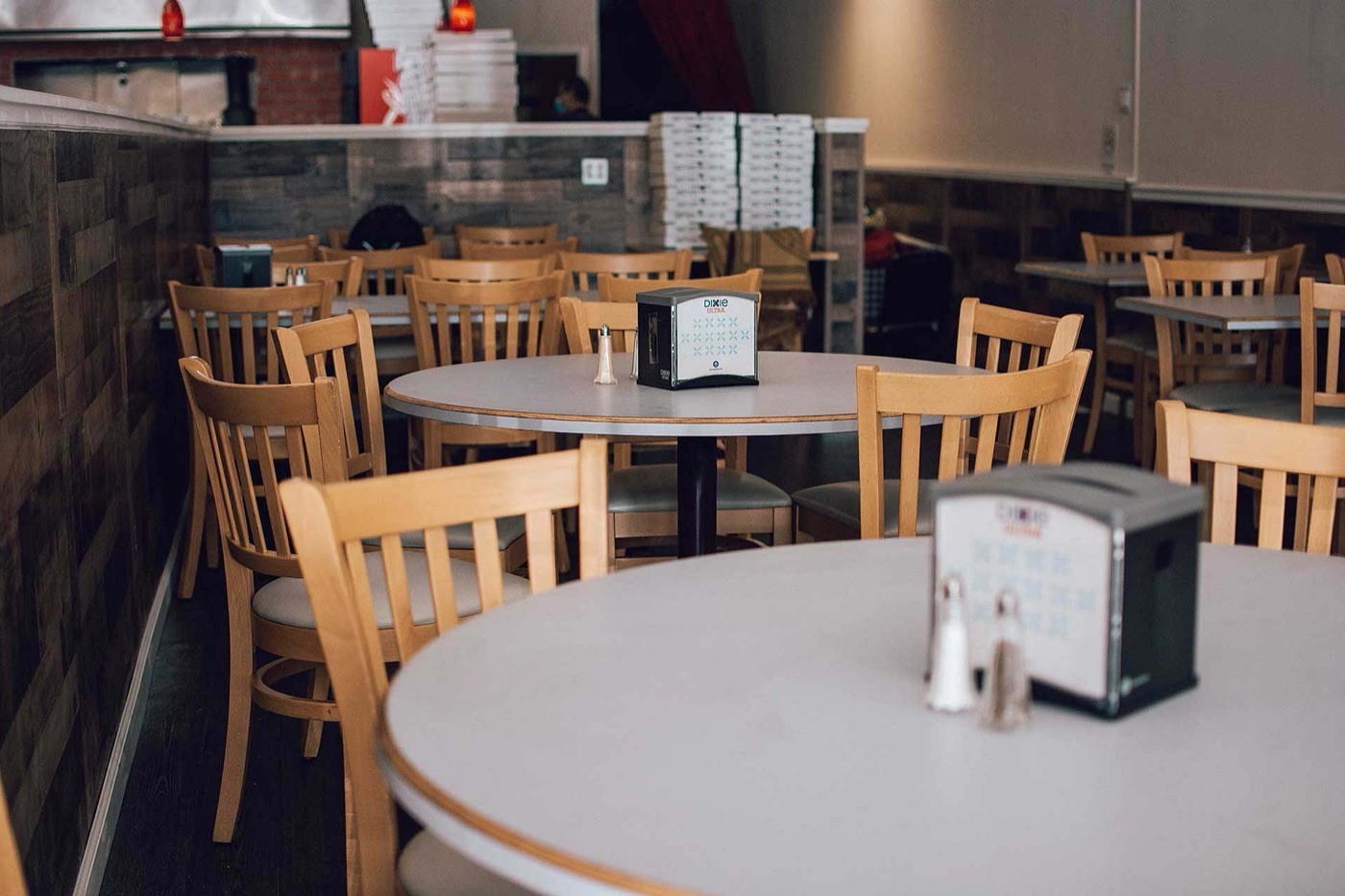 Inside Nunzio’s dining room with wooden chairs and tables set for guests